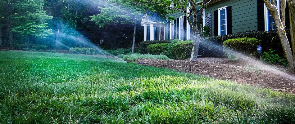 Sprinklers running on a front lawn in Pittsboro, NC.
